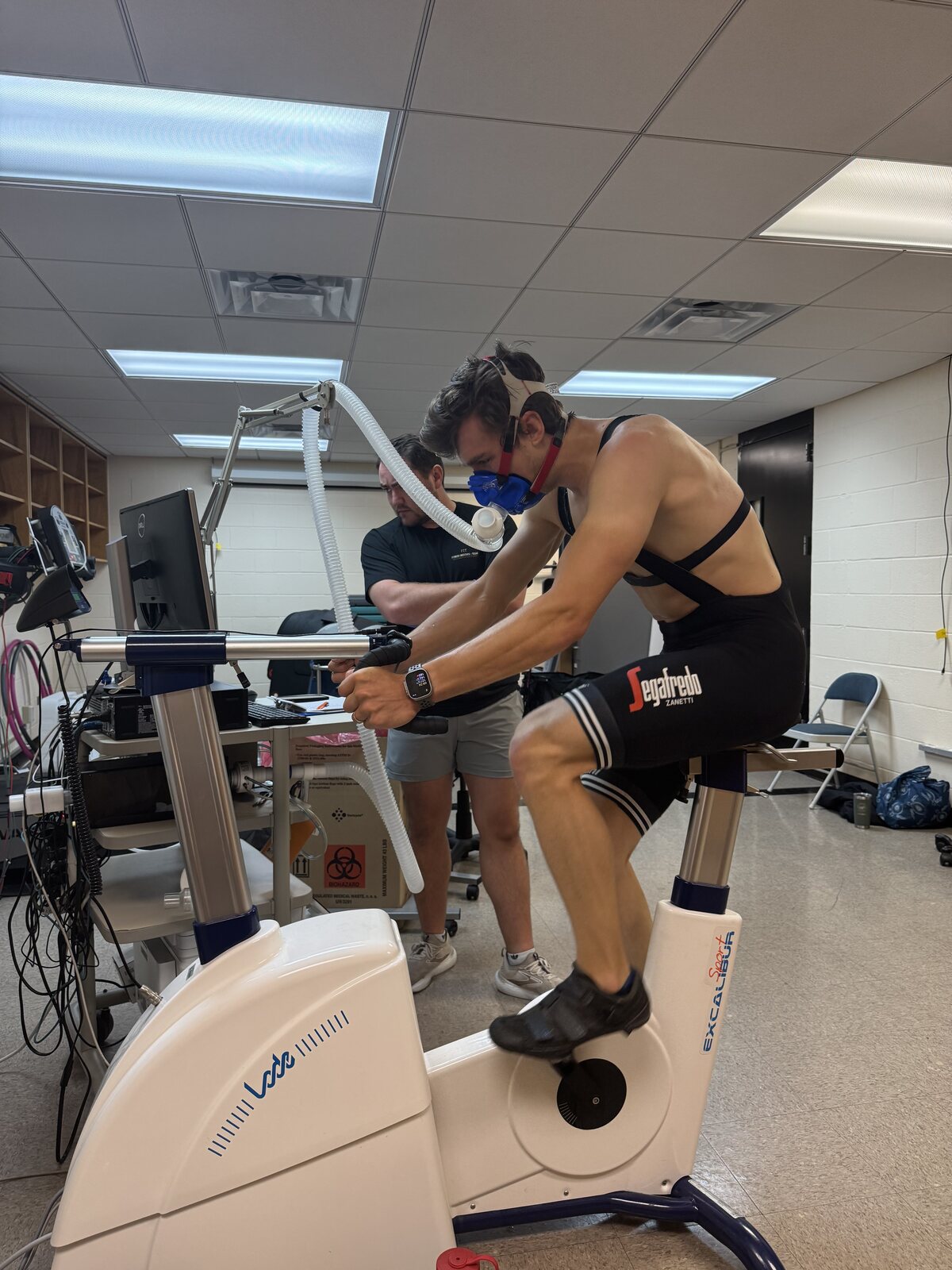 Matthew on a lab ergometer wearing a VO2 mask during a physiology test