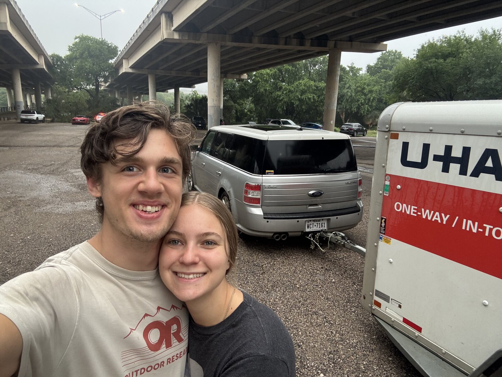 Matthew and Kaitlynn standing next to a U-Haul on the road to Los Angeles
