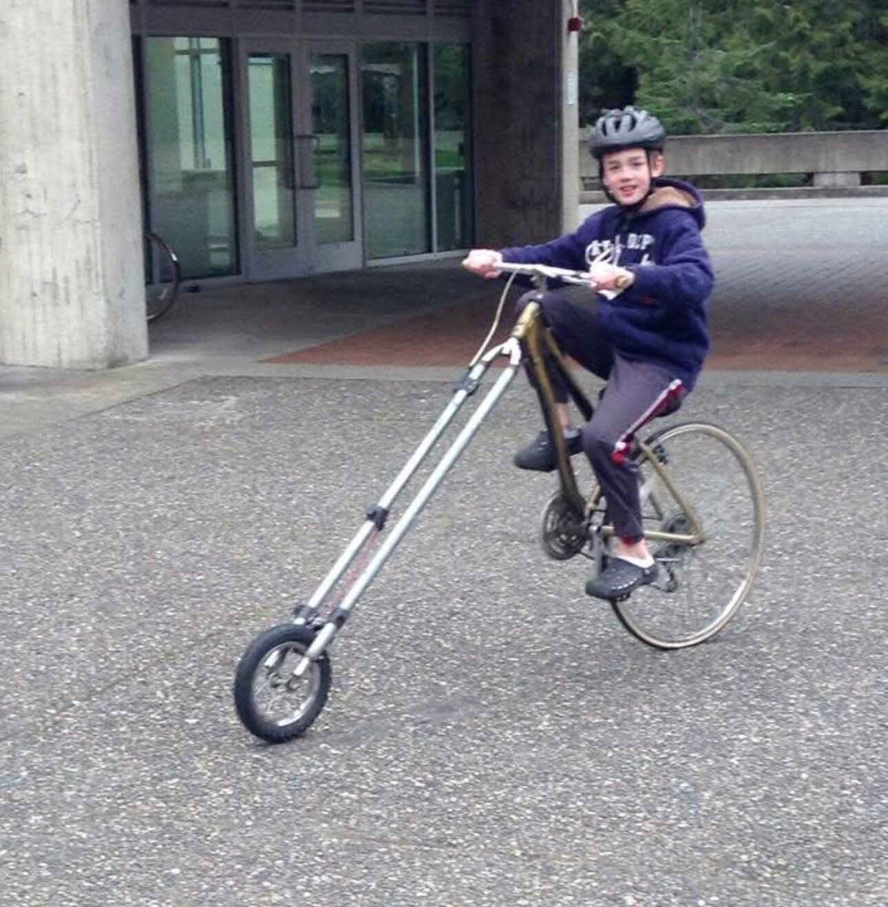 Younger Matthew riding a custom long-fork bike build