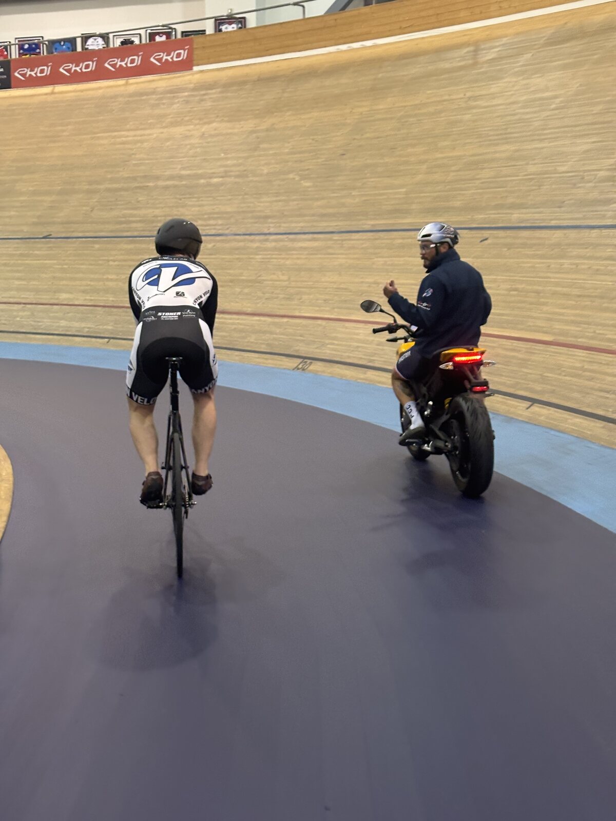 Matthew motorpacing on the velodrome with his coach on a motorcycle pacing him
